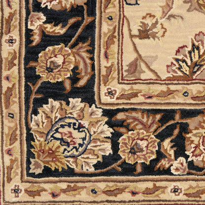 Close-up of a Persian-style rug with floral motifs: navy border, warm beige field, gold and cream tones, subtle red accents.