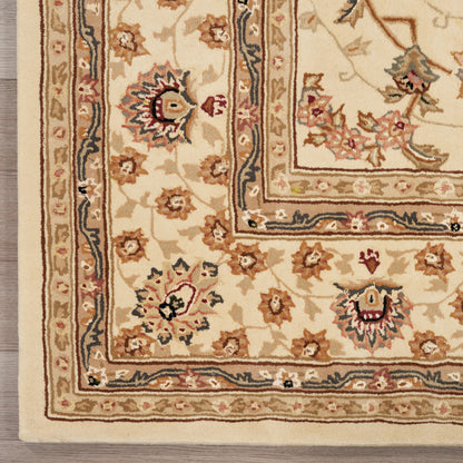 Beige oriental-style area rug with layered cream, tan and navy borders and floral motifs.