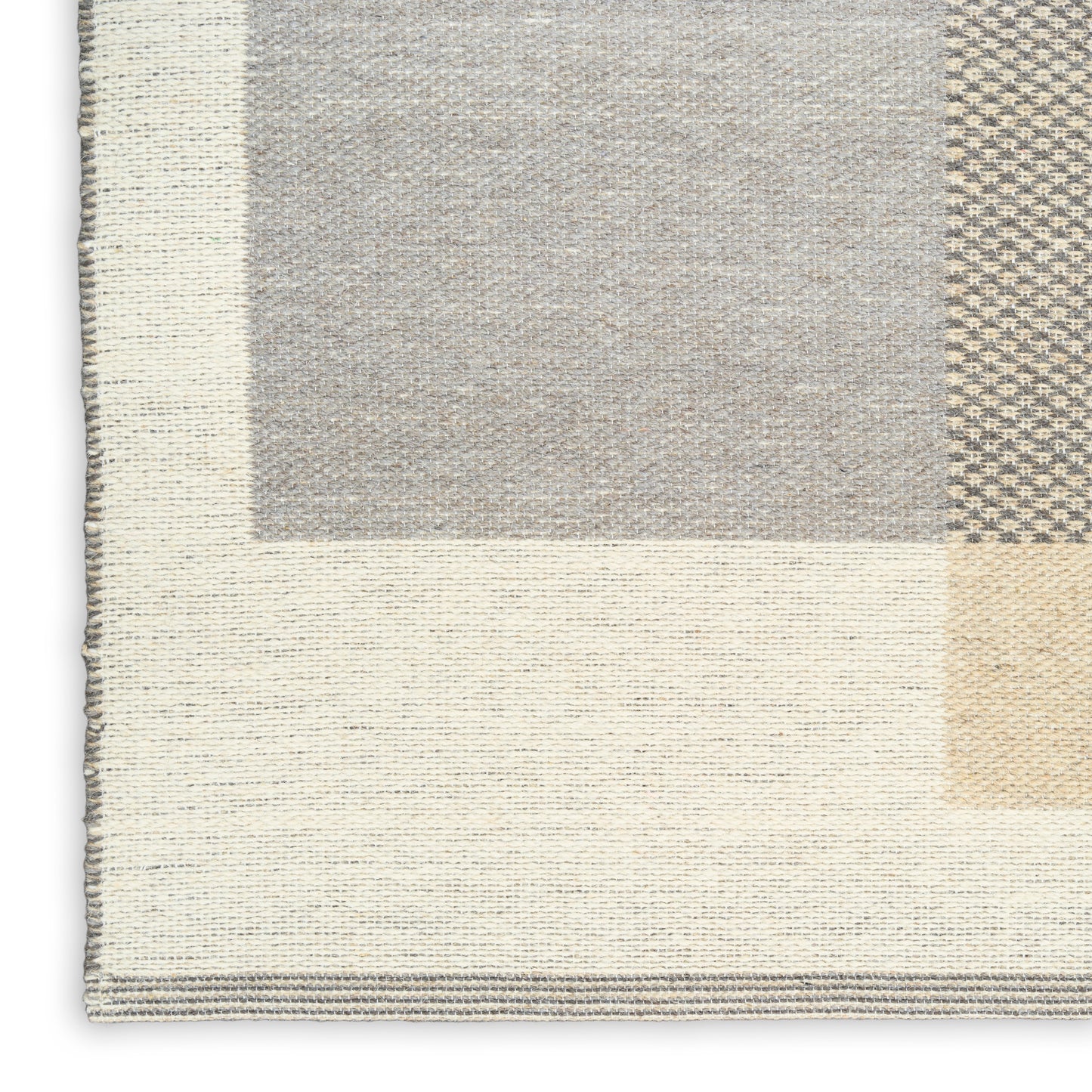 Neutral patchwork rug with cream, beige and gray blocks; woven texture, rectangular shape, modern cozy decor.