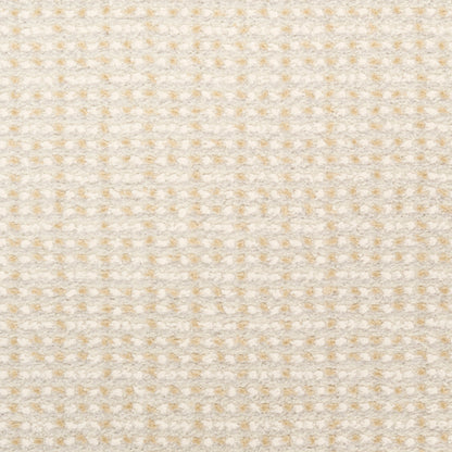 Beige cream fabric with pale yellow dotted waffle pattern; soft textured textile for clothing or upholstery.