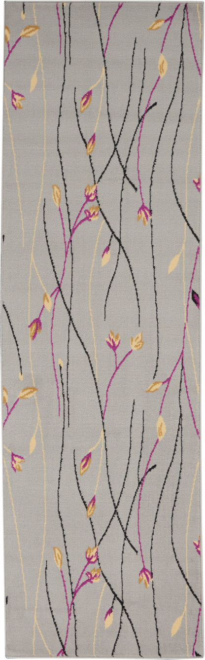 Rectangular gray area rug with black and magenta twisting branches and pale yellow leaves in a modern botanical print.