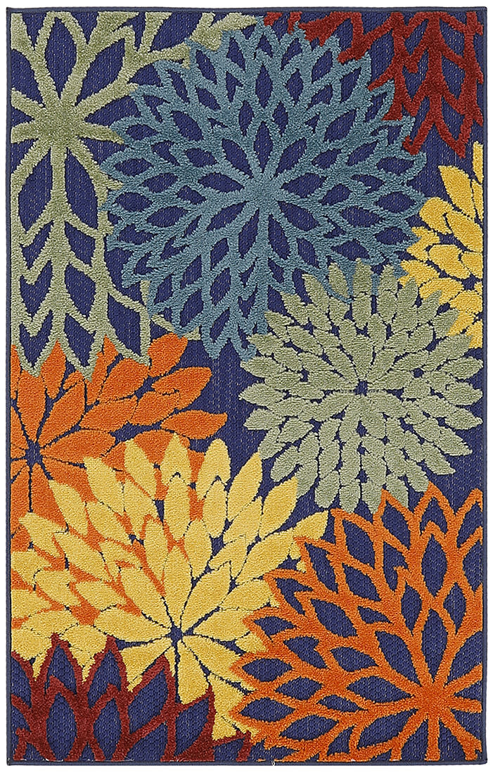 Woven rug with bold overlapping daisy-like flowers in blue, yellow, orange, and green on a dark navy background.