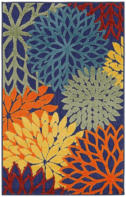 Woven rug with bold overlapping daisy-like flowers in blue, yellow, orange, and green on a dark navy background.