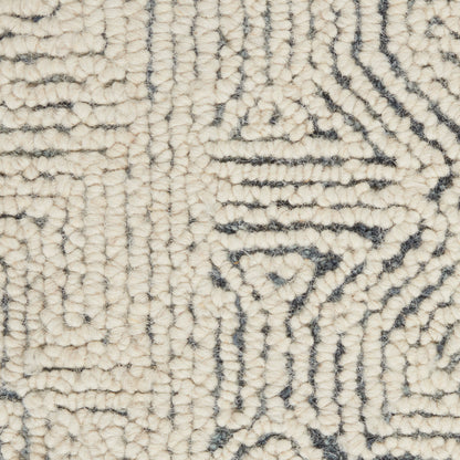 Cream shag rug with dark blue-gray geometric maze pattern and a looped pile texture.