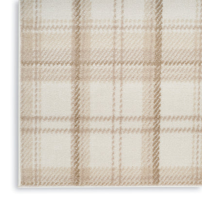 Beige plaid rug with cream and light brown checks; soft woven texture and visible stitched edge.
