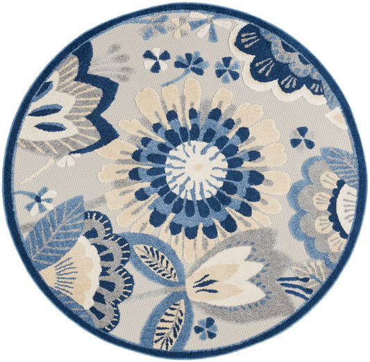 Round floral rug in blue, cream & beige tones; woven texture, decorative rug for living room.