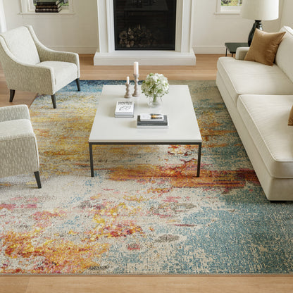 Modern living room with cream sofa and armchairs, white square coffee table, colorful abstract rug, fireplace and decor.