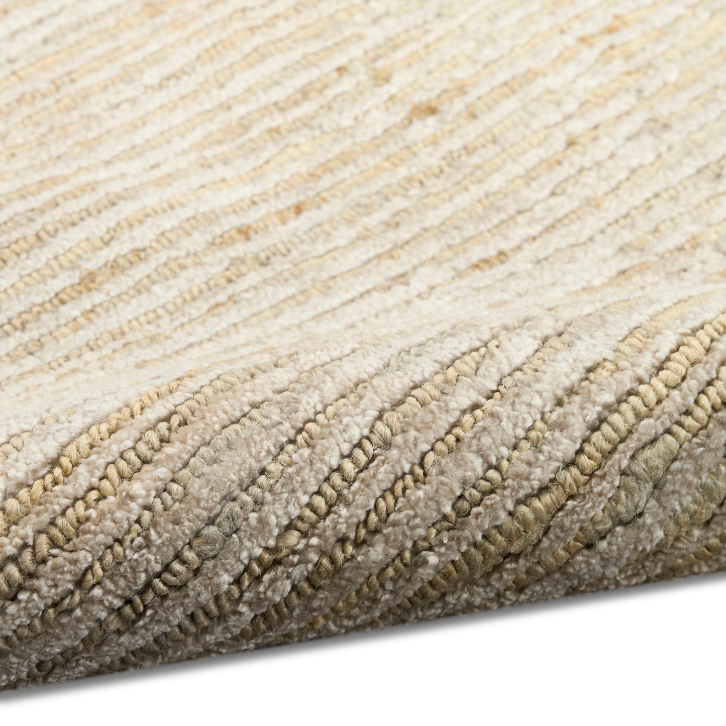 Beige cream plush rug close-up with thick looped pile and rolled edge.