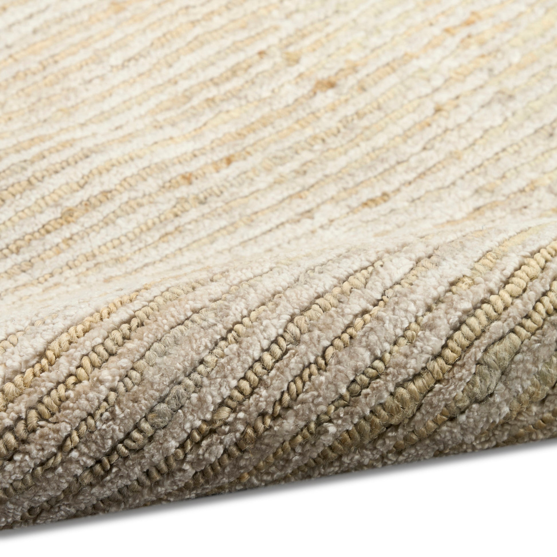 Beige cream plush rug close-up with thick looped pile and rolled edge.