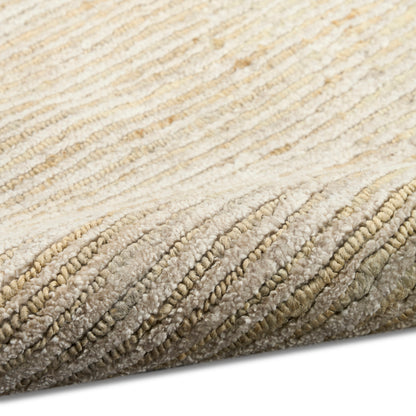 Beige cream plush rug close-up with thick looped pile and rolled edge.