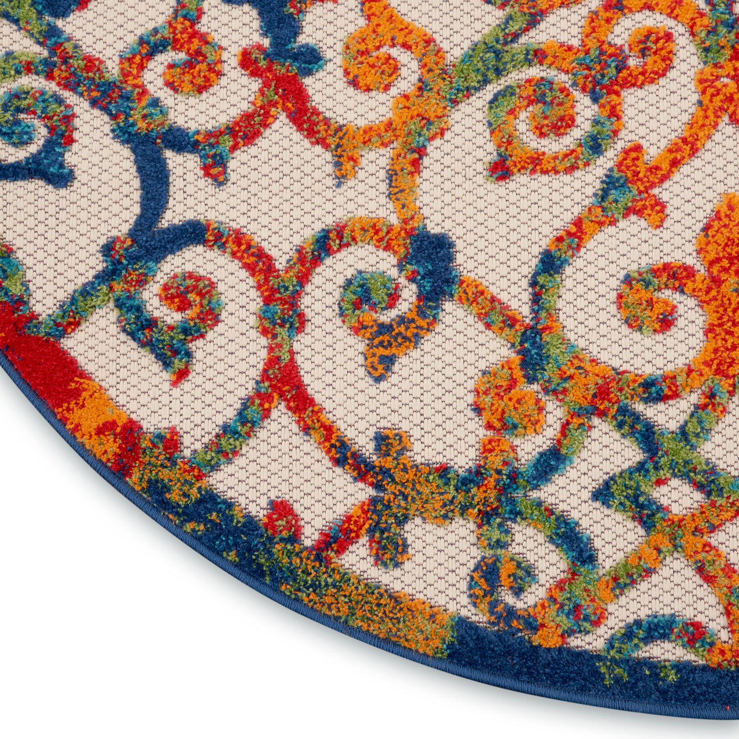 Round area rug with vivid multicolor scrollwork in orange, blue, red & green on ivory, navy edge.