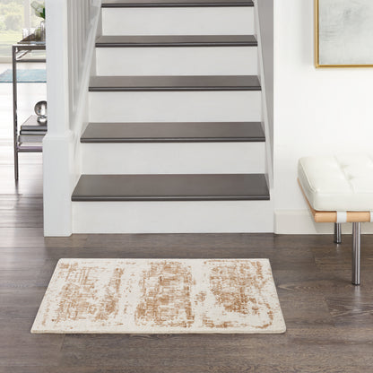 Modern entryway: white staircase with dark wood treads, beige patterned rug, white bench with chrome legs.