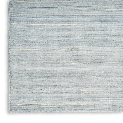 Light blue-gray woven rug with subtle horizontal stripes; rectangular, casual floor decor.