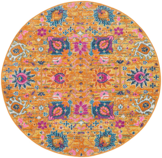 Round orange rug with a vivid pink, teal and blue floral pattern in a Persian-inspired design.