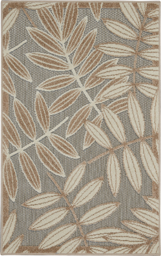 Neutral botanical rug with cream and tan leaves on a gray woven backdrop, bordered in tan.