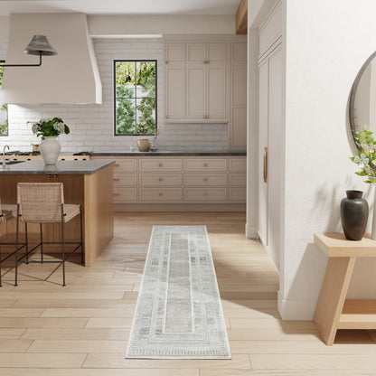 Bright white kitchen with light wood island, white cabinets, subway tile, and a grey patterned runner rug.