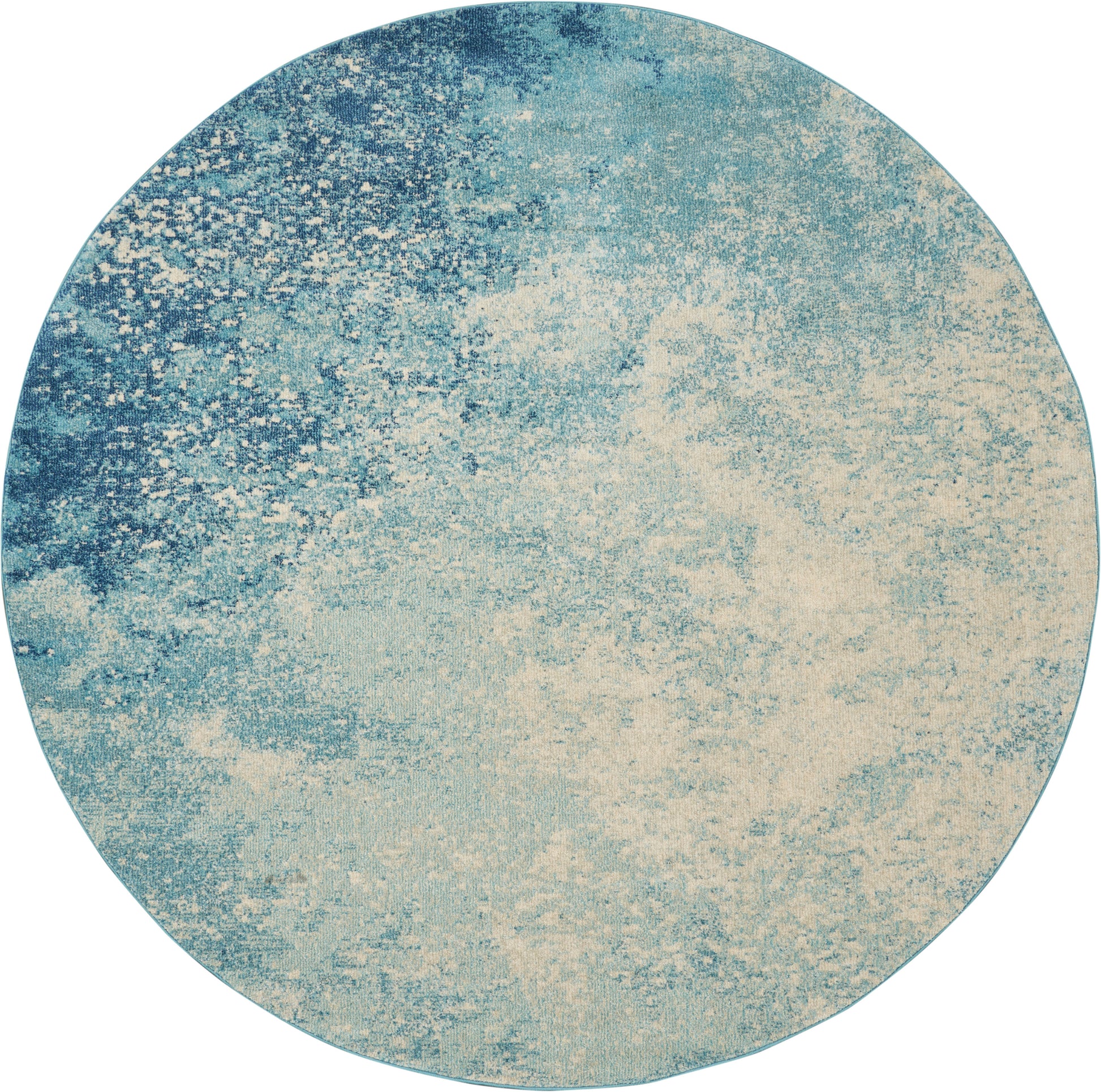Round rug with blue to beige abstract gradient and textured surface.