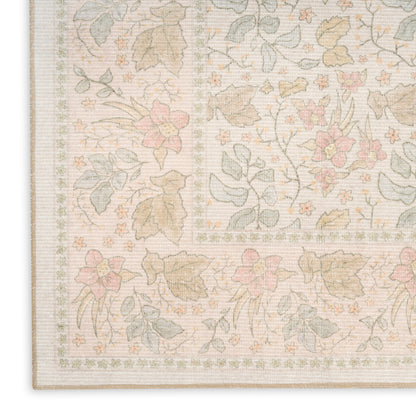 Pastel floral area rug in pale pink, sage green and beige with an intricate border motif.