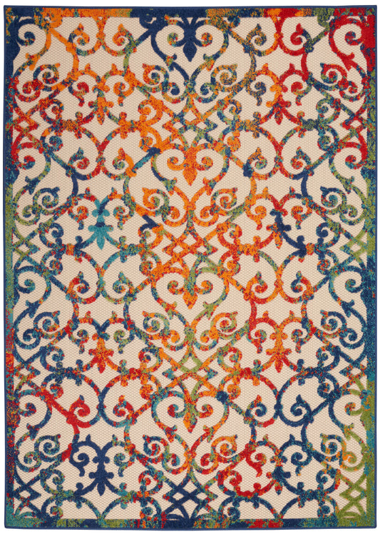 Rectangular woven rug with vibrant rainbow scrollwork lattice on pale background and dark blue border.
