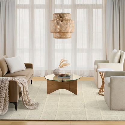 Neutral living room with beige sofas, knit throw, glass-top coffee table on a light rug under a woven rattan pendant light.