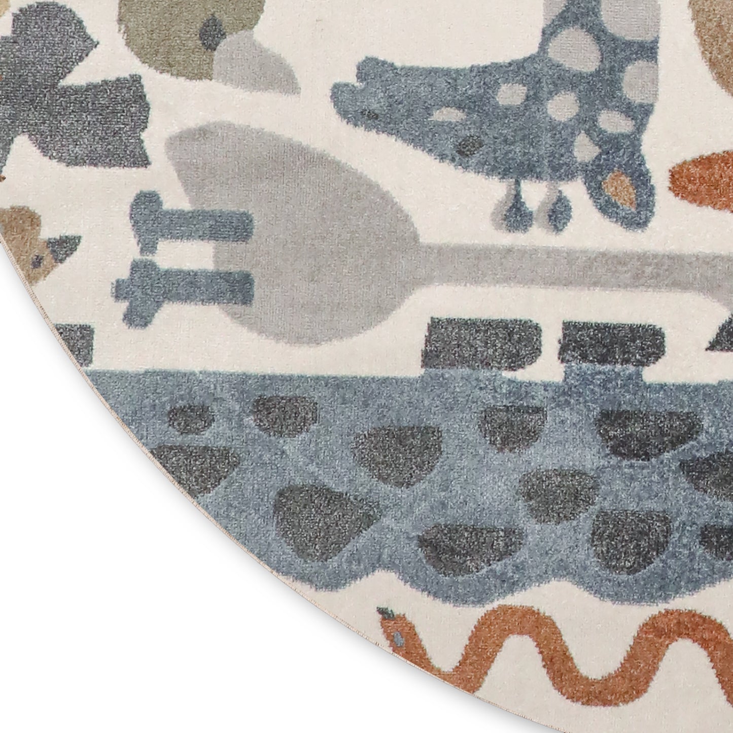 Round plush rug with abstract blue/gray animal shapes and wave motifs on cream background, orange wavy line accent