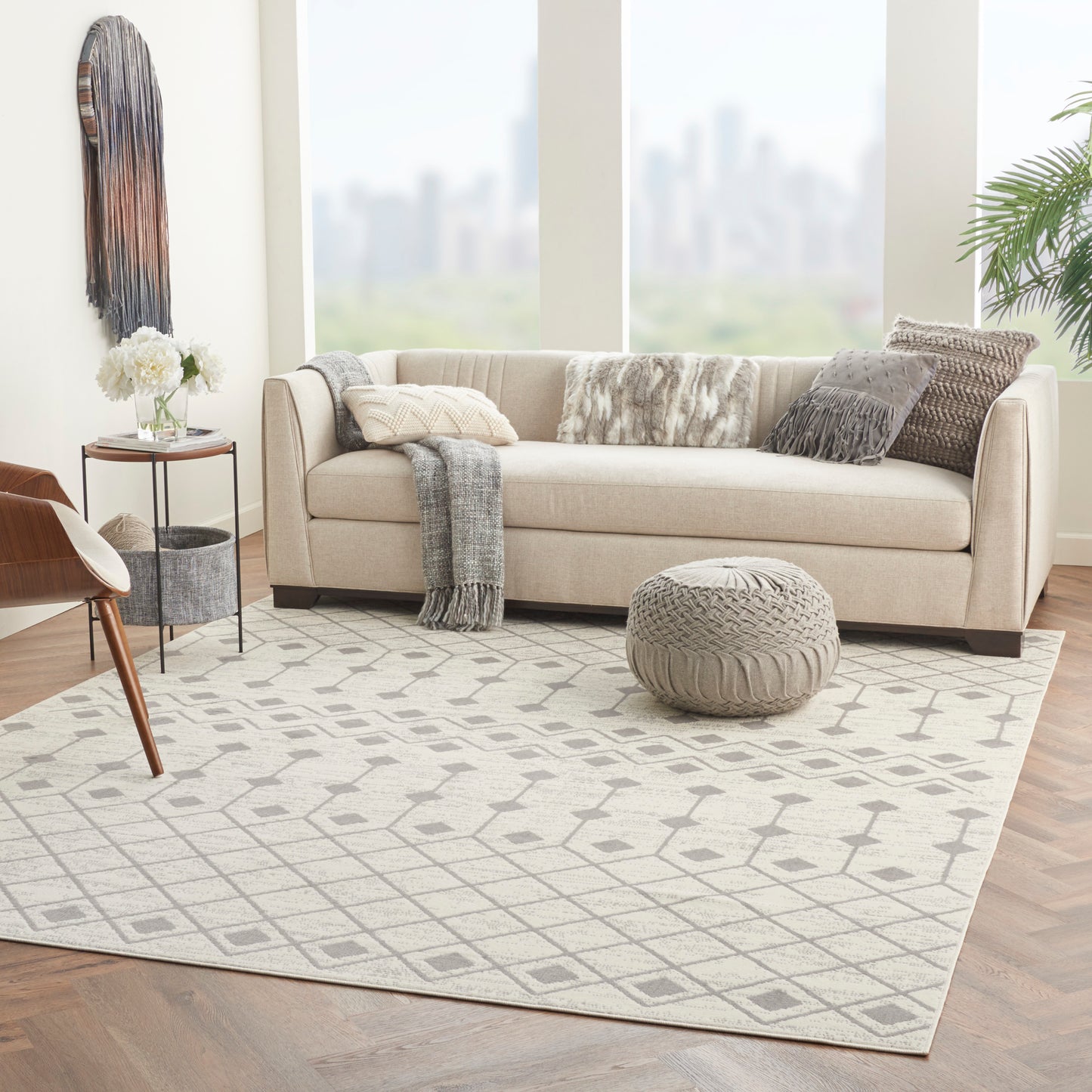 Bohemian rug with a light gray geometric pattern in a bright modern living room.