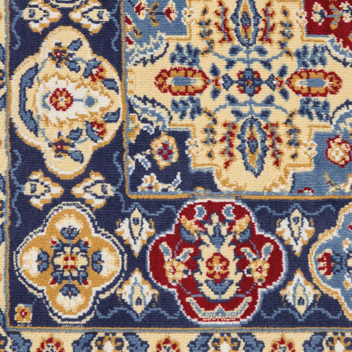 Traditional Persian-style area rug with blue field, ivory and gold floral medallions, red accents, ornate border.