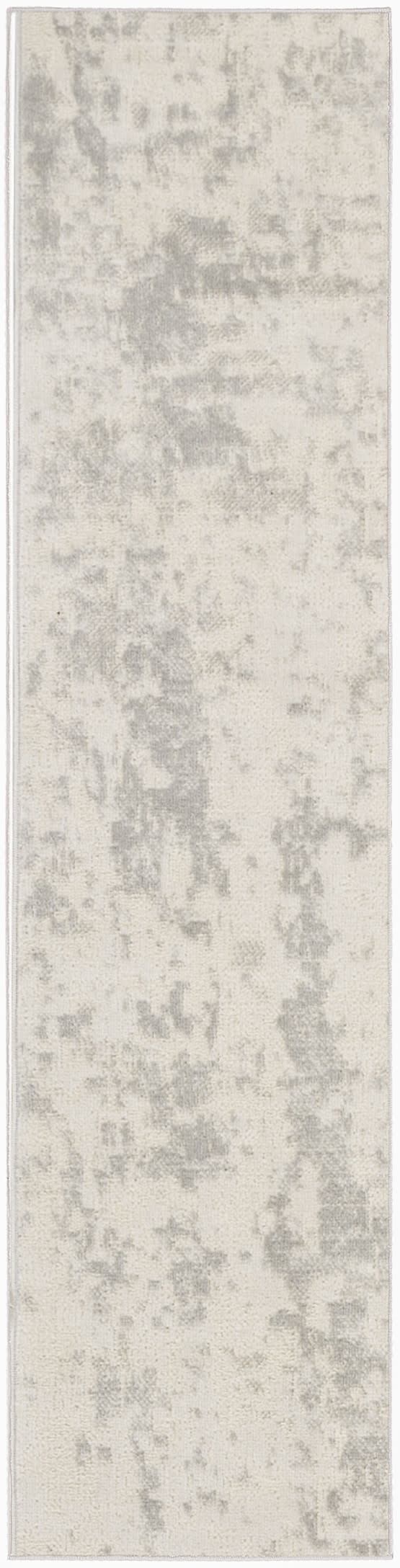 Long, narrow rug runner in light grey and ivory with a subtle distressed pattern for contemporary hallway decor.