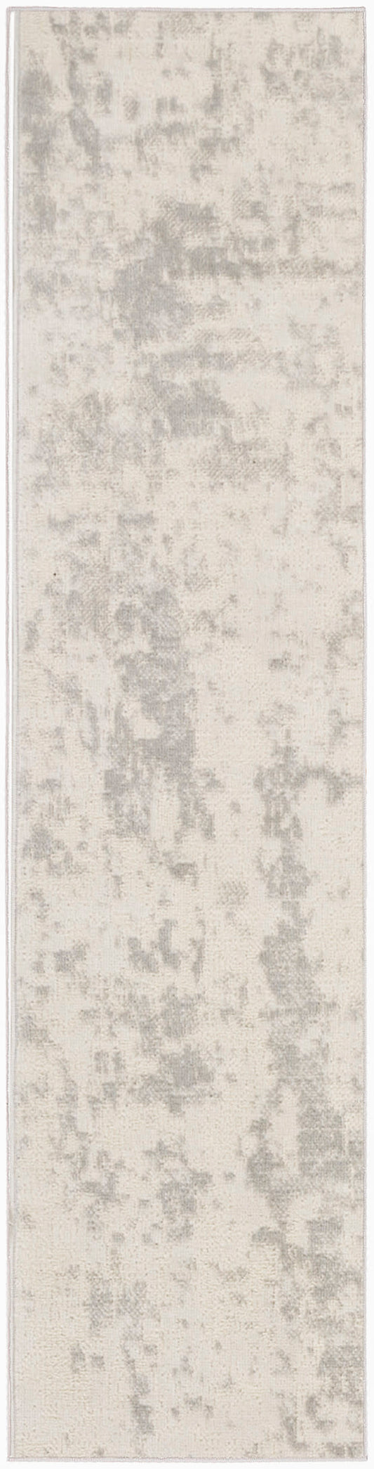 Long, narrow rug runner in light grey and ivory with a subtle distressed pattern for contemporary hallway decor.