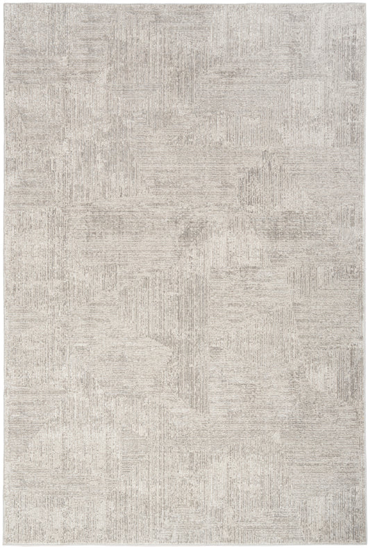Beige rectangular area rug, 5' x 7', with cream-toned geometric patchwork pattern and subtle textured surface.