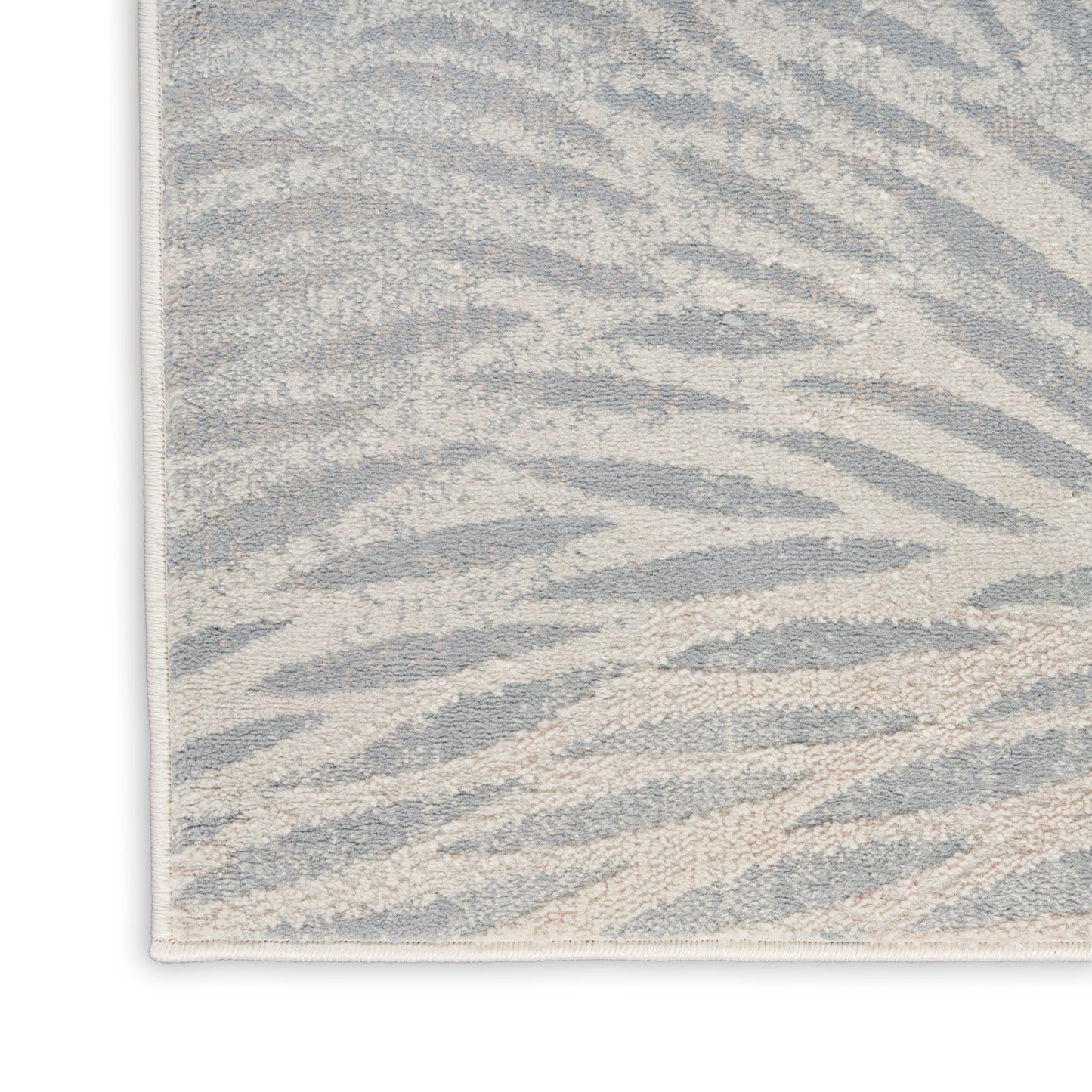 Rectangular zebra-print rug in light gray and ivory, plush textured surface for modern living spaces.