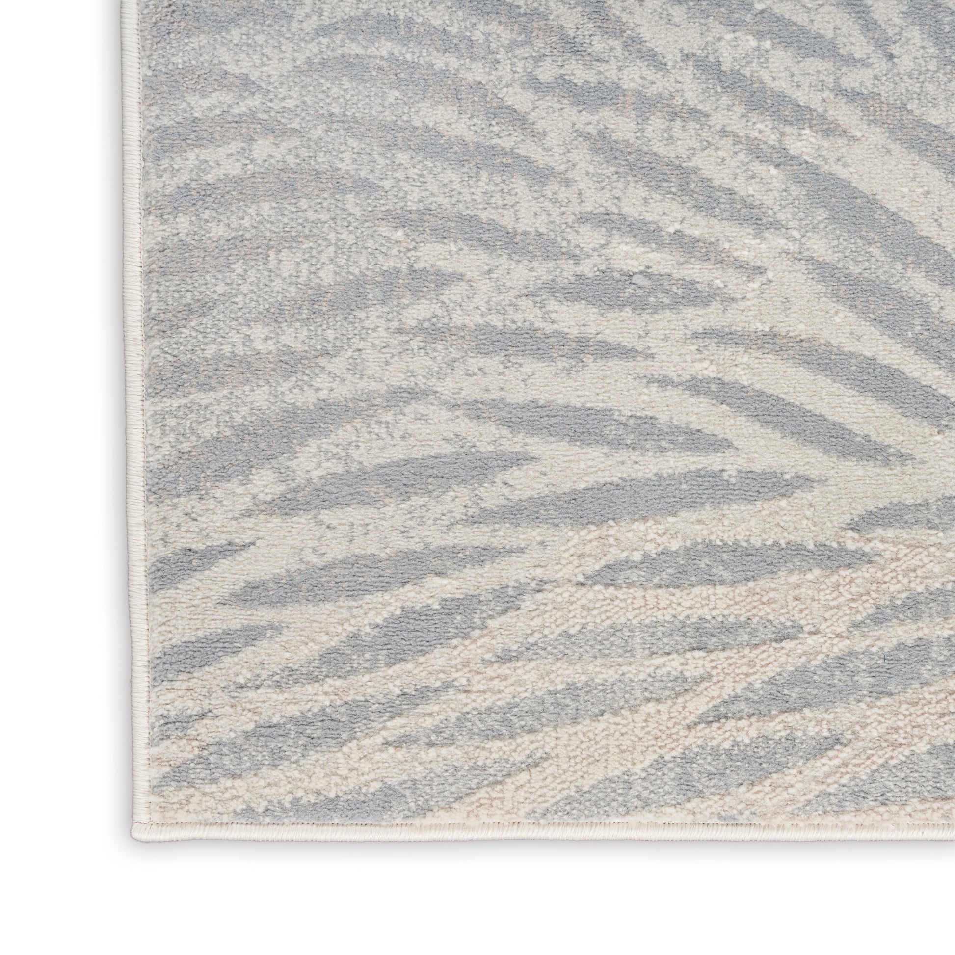 Rectangular zebra-print rug in light gray and ivory, plush textured surface for modern living spaces.