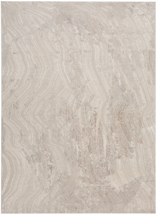 Beige area rug with cream and taupe, featuring a soft, wavy wood-grain pattern.