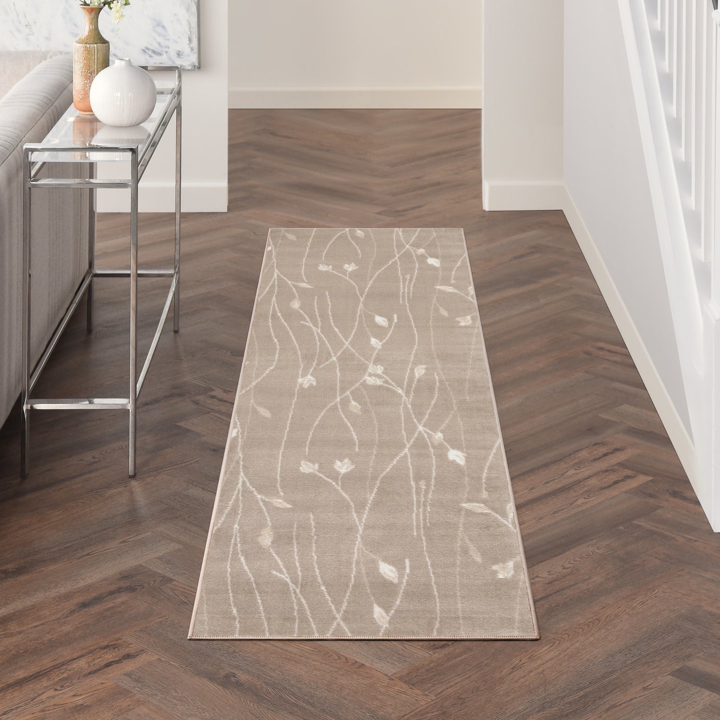 Beige hallway runner rug featuring a white abstract botanical branch pattern; long rectangular, ideal for entryways.