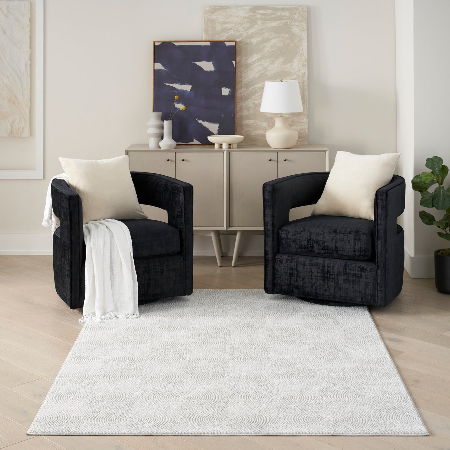 5' x 7' modern area rug with a light textured surface in a neutral living room.