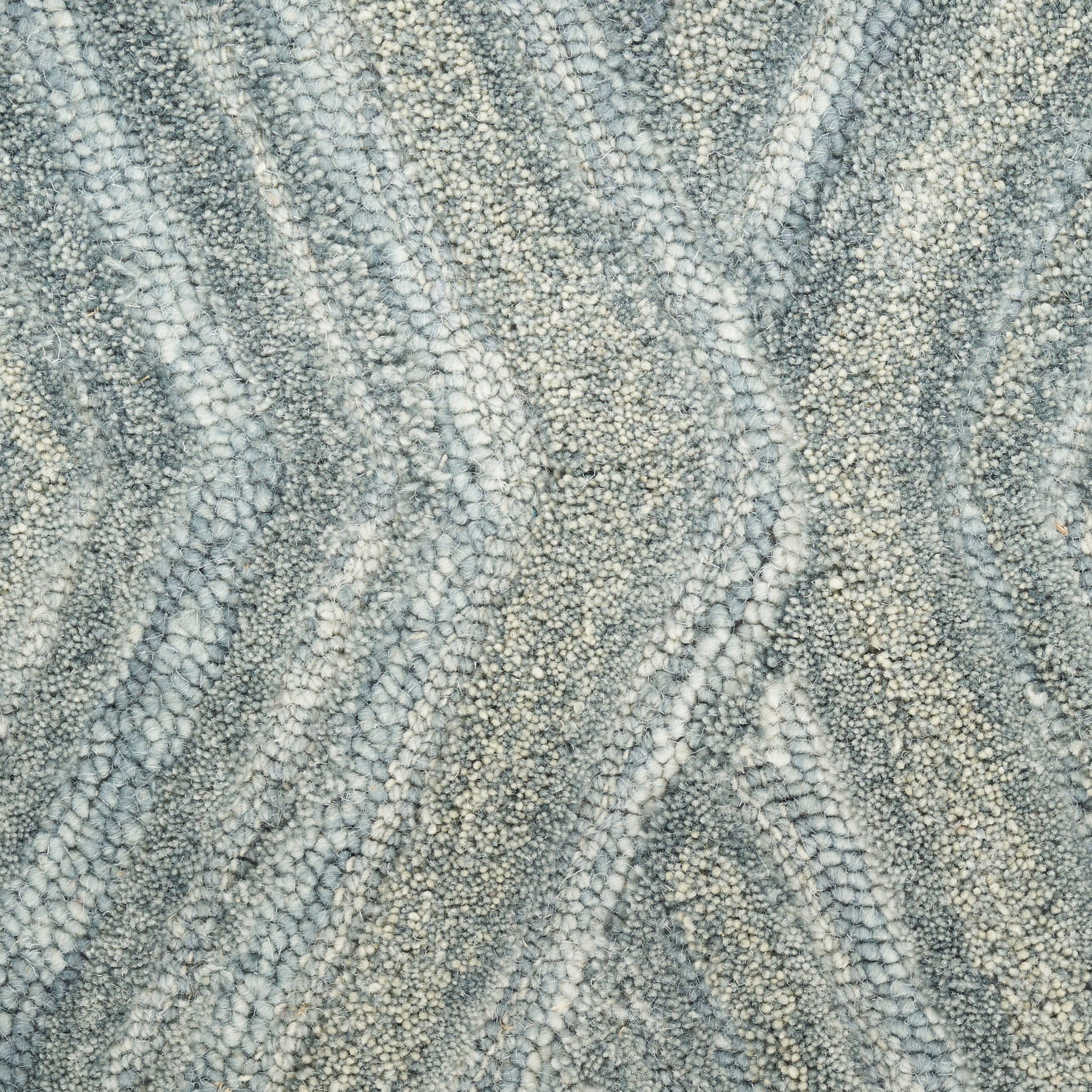 Gray and ivory loop-pile rug with a soft, textured, wavy chevron pattern.