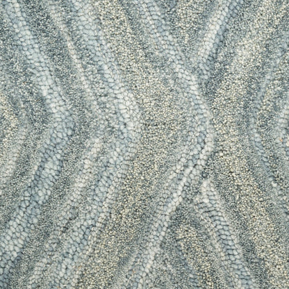 Gray and ivory loop-pile rug with a soft, textured, wavy chevron pattern.