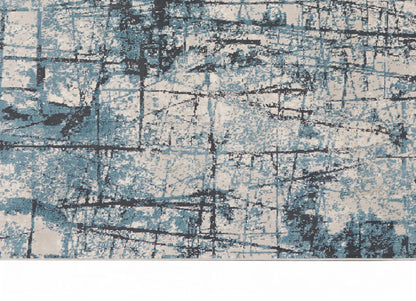 Abstract blue and cream area rug with distressed grid pattern and dark lines; modern decor.