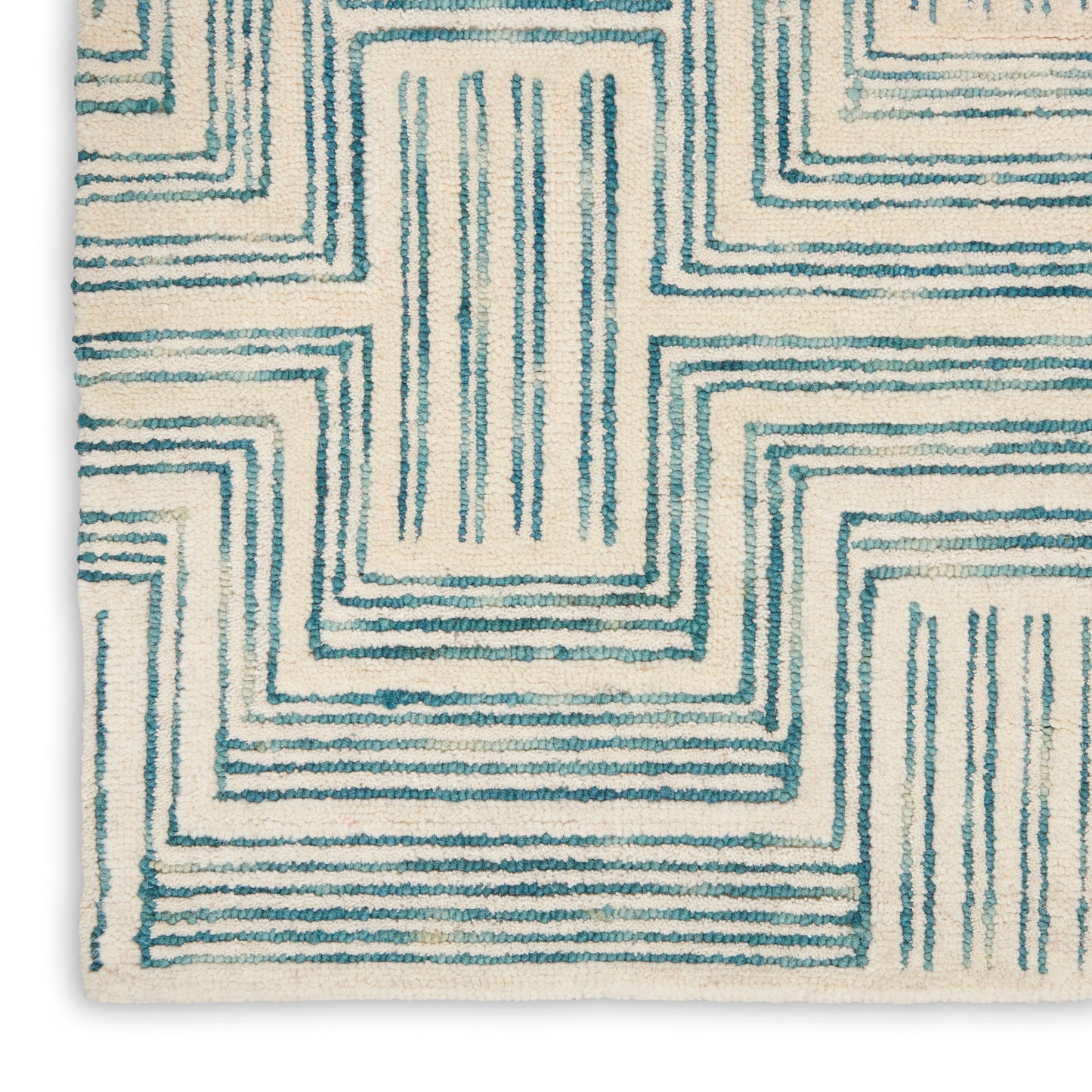 Teal geometric rug with stepped rectangular lines on cream background; modern abstract pattern.