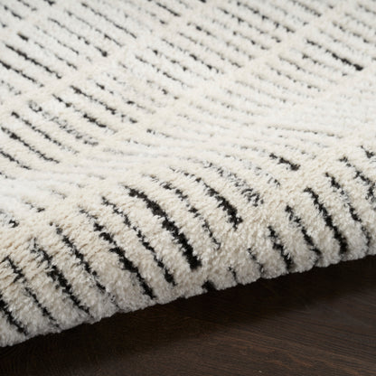 Cream textured shag rug with black striped pattern, plush loop pile on dark wooden floor.