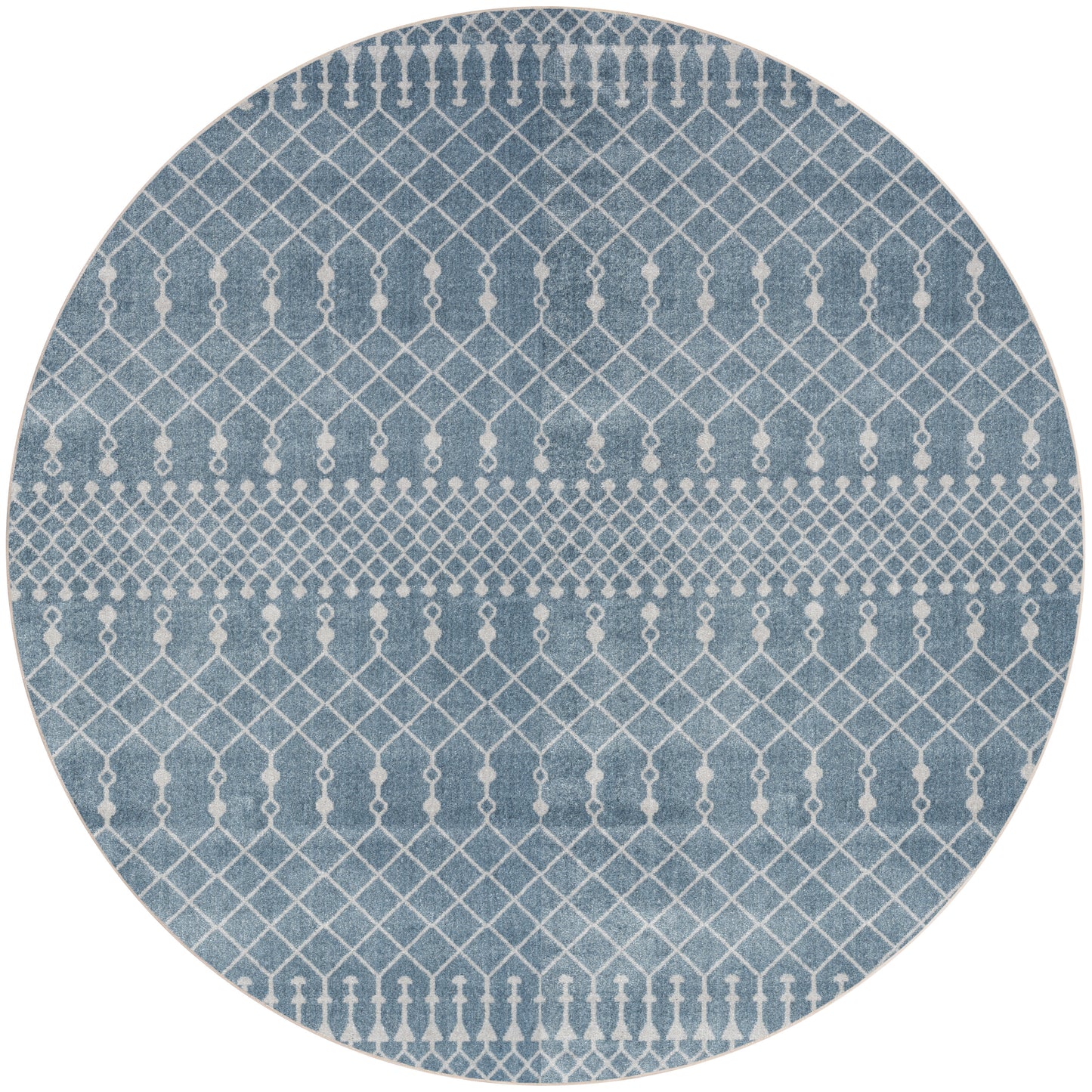 Round blue rug with white geometric lattice and diamond stripe pattern.
