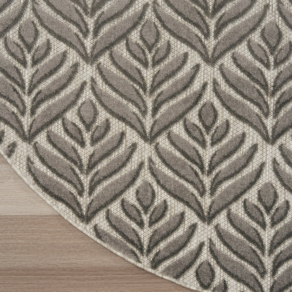 Neutral taupe and beige rug with leaf-patterned, textured fronds on a light wood floor.