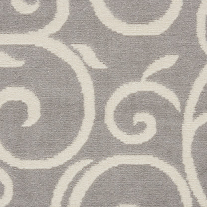Grey rug with ivory swirling pattern, plush pile, decorative floor covering.