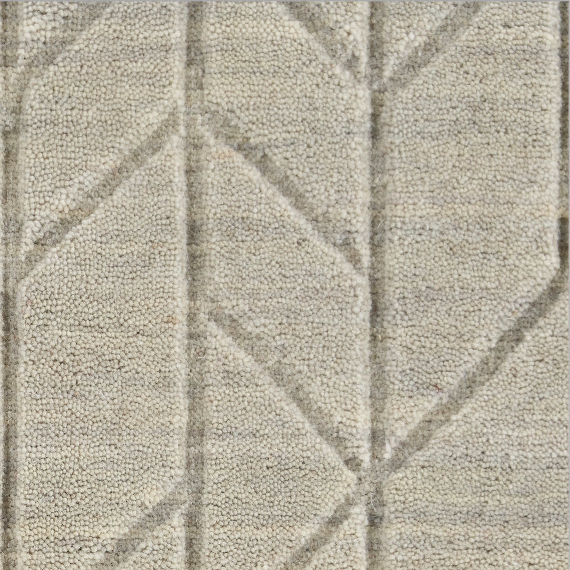 Beige-gray tufted rug with geometric diamond pattern, soft pile and raised textured lines.