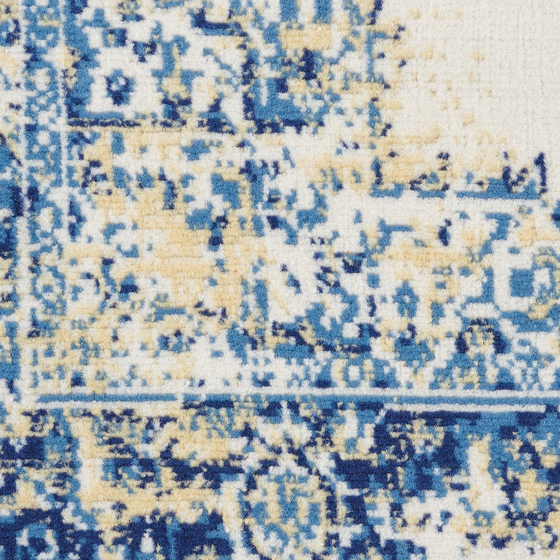 Close-up of blue, cream & beige patterned rug with distressed geometric motif; woven texture; ideal for living room decor.