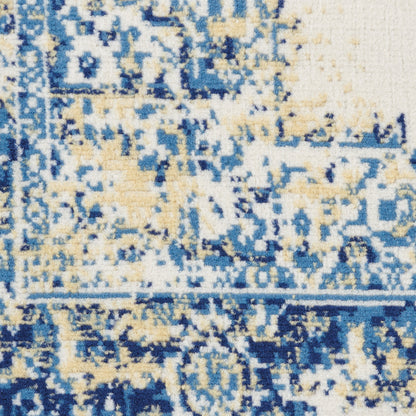 Close-up of blue, cream & beige patterned rug with distressed geometric motif; woven texture; ideal for living room decor.