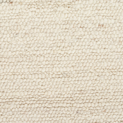 Cream boucle rug close-up with dense looped pile, soft and cozy.