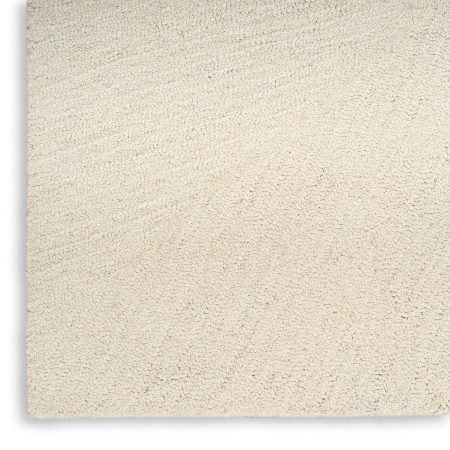 Cream beige plush rug with dense loop pile and subtle swirled texture, close-up view.