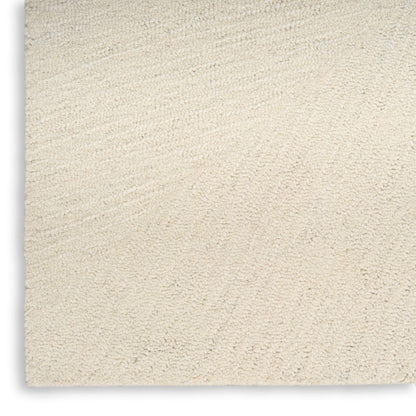 Cream beige plush rug with dense loop pile and subtle swirled texture, close-up view.