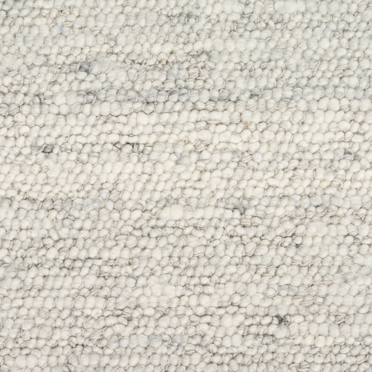 Cream boucle rug close-up with dense loop pile and subtle gray specks, soft textured surface.